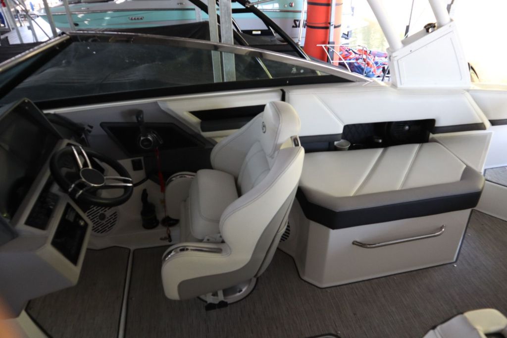 Interior view of a 2021 Cobalt R6 boat showcasing the driver's seat, steering wheel, and dashboard controls.