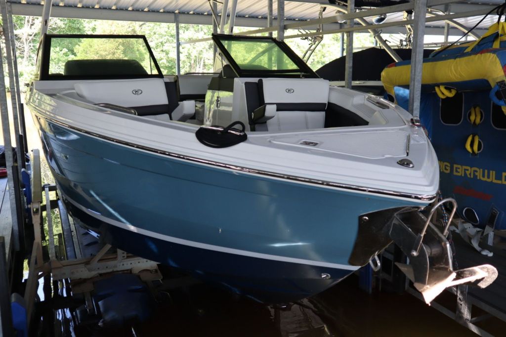 A 2021 Cobalt R6 boat in a covered slip, showcasing its blue hull and sleek design.