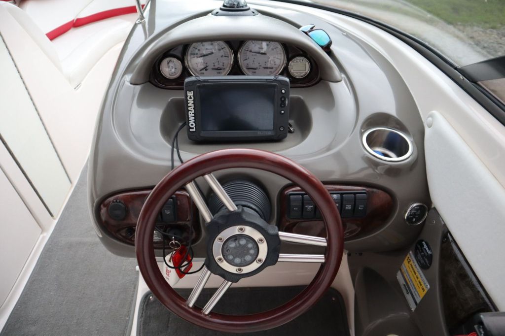 Top view of the dashboard of a 2007 Regal 2400 Bowrider, featuring a steering wheel, gauges, and a Lowrance display.
