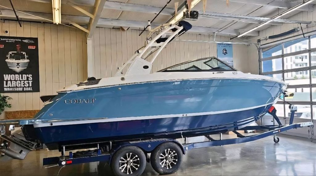 2021 Cobalt R6 boat on a trailer inside a showroom, showcasing its sleek blue exterior and premium build.