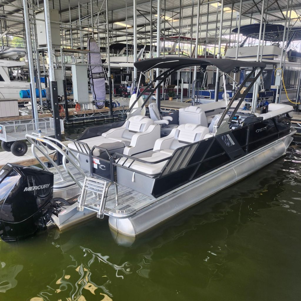 2019 Crest Caliber 250 Tritoon with a Mercury 300 HP engine docked at a marina, featuring spacious seating and a contemporary design.