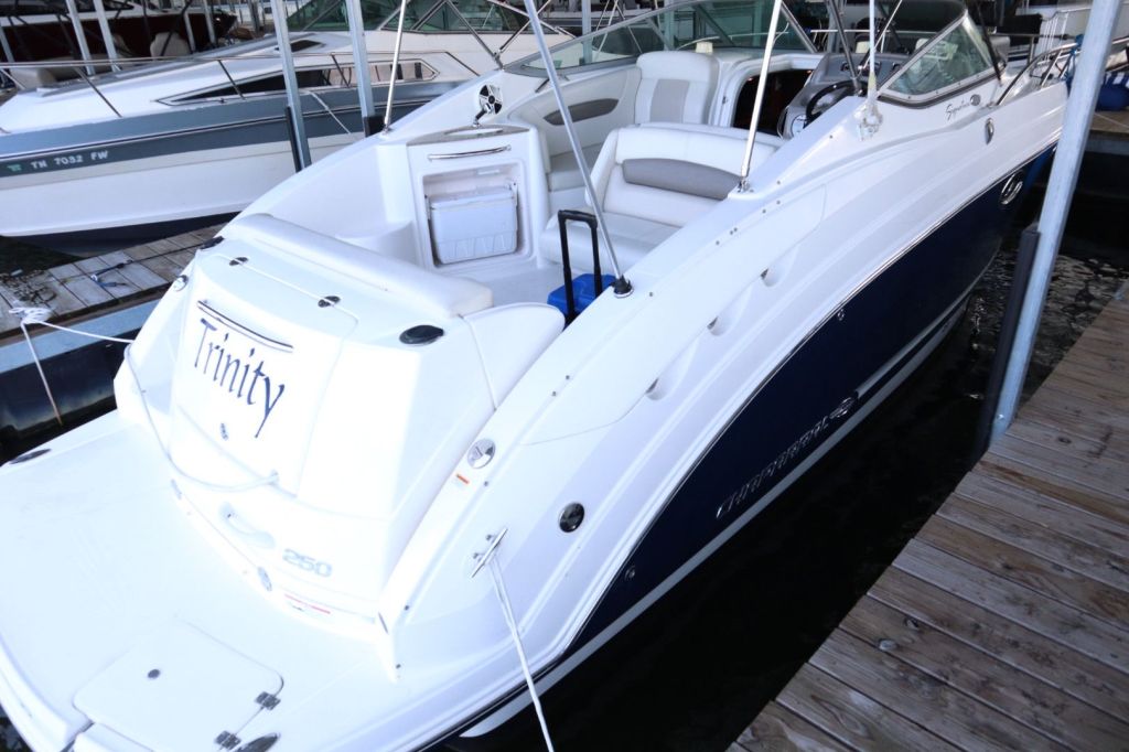 View of a 2009 Chaparral 250 Signature boat docked at a marina, showing the stern and cockpit area.